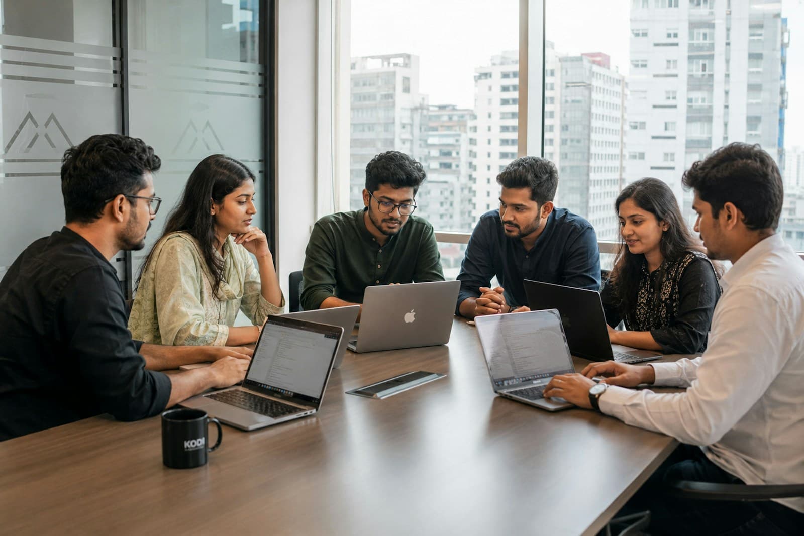 A team working together around a table with laptops